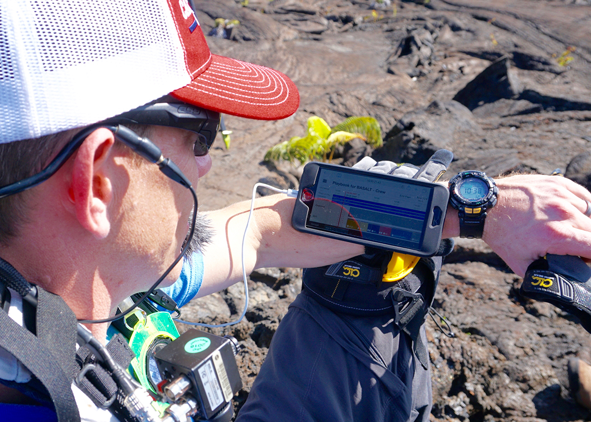 Biologic Analog Science Associated with Lava Terrains (BASALT) team member watches Playbook Timeline while out in the field during a simulated extravehicular activity (EVA)